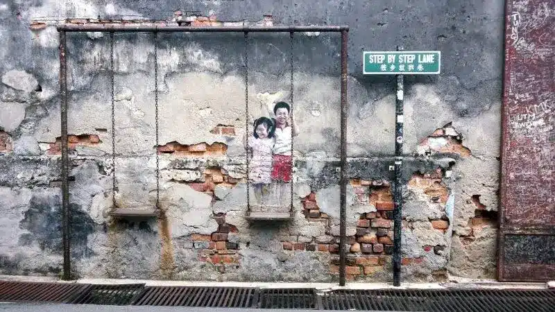 brother and sister on a swing brother and sister on a swing street art penang